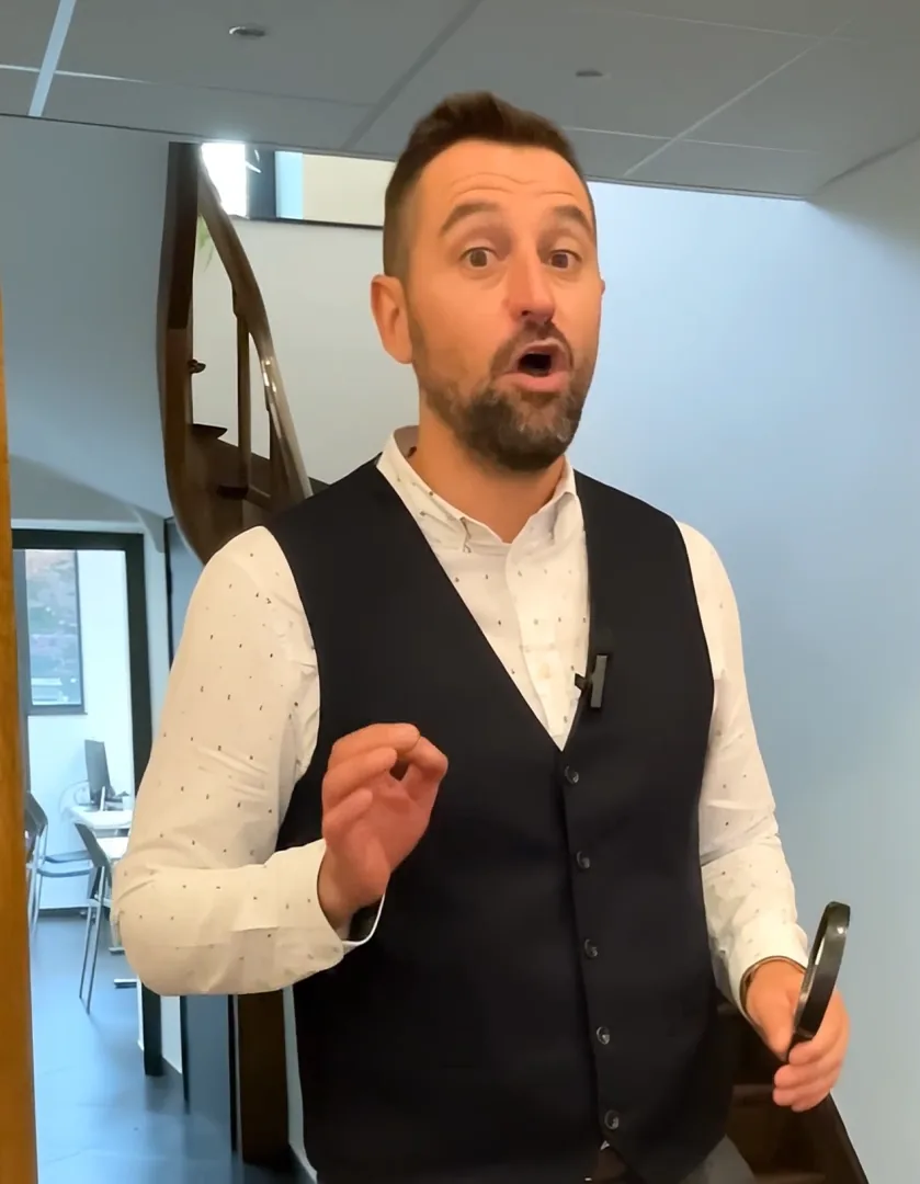 Christophe, broker at Bauvir Assurances, talking to camera in the office