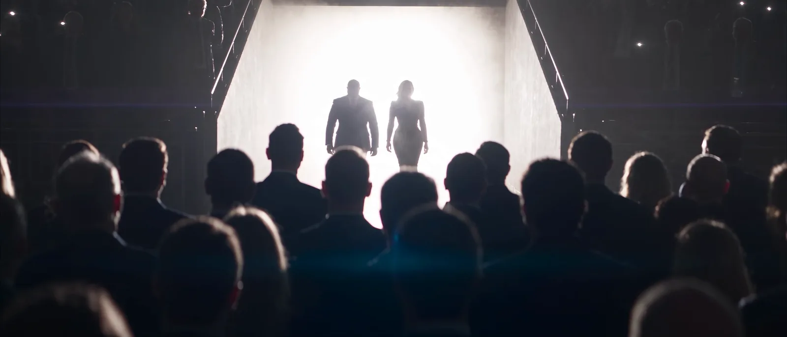 Two backlit silhouettes appear in the players' tunnel