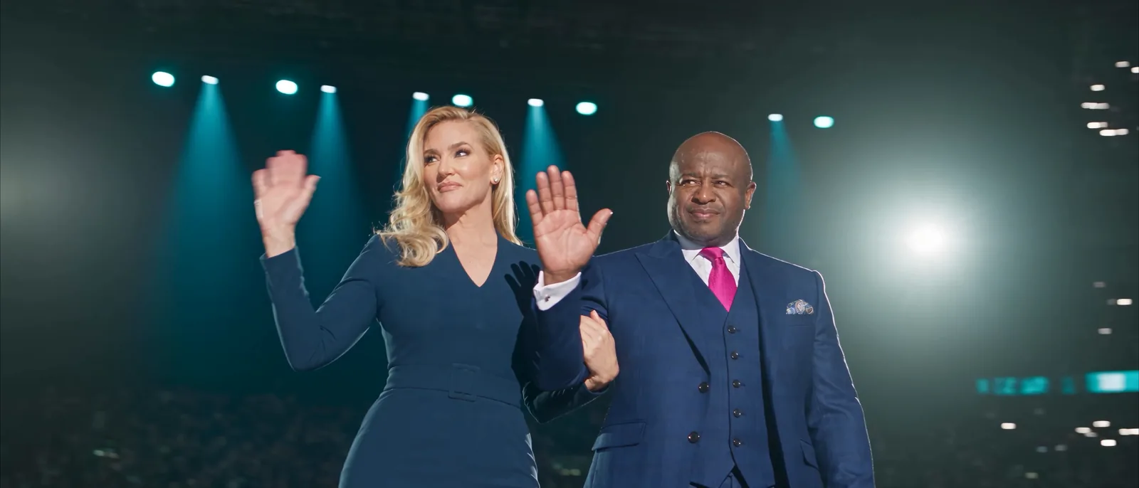 Brooke and Sarano on stage, waving to the arena